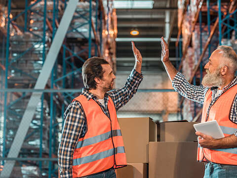 Warehouse workers with digital tablet 909613070 726x484